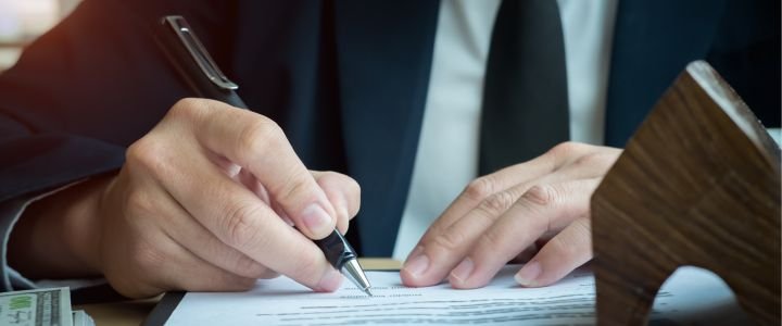A Person Writing on Notebook