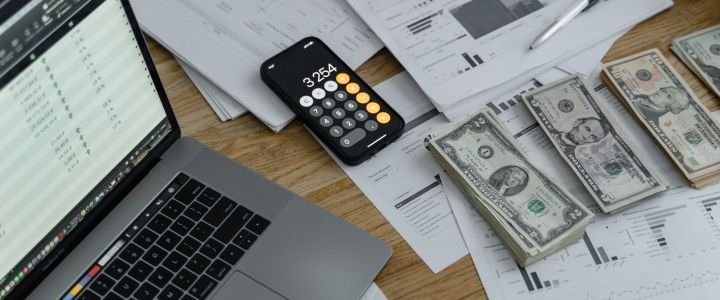 Banknotes and Calculator on Table