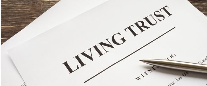 Living trust papers with pen and book.