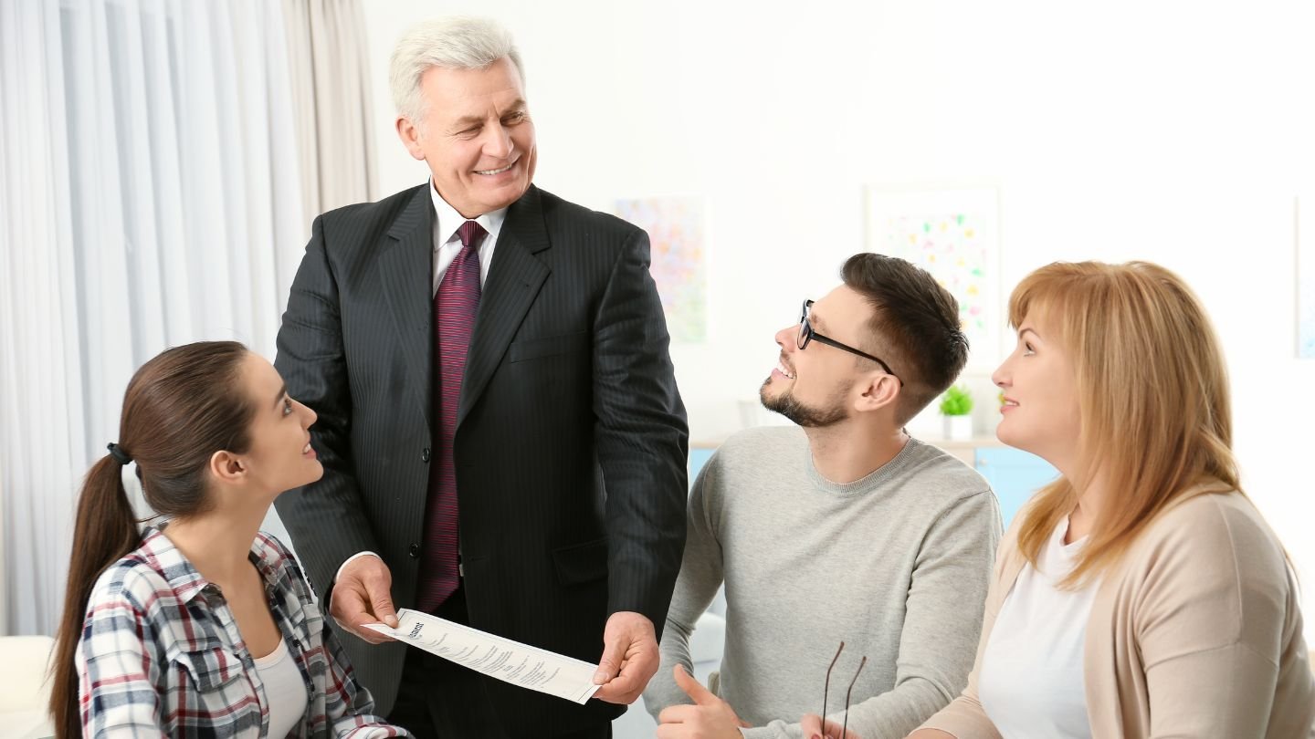 "A family looking at financial documents with an estate planner, ensuring their assets are protected from legal claims and probate