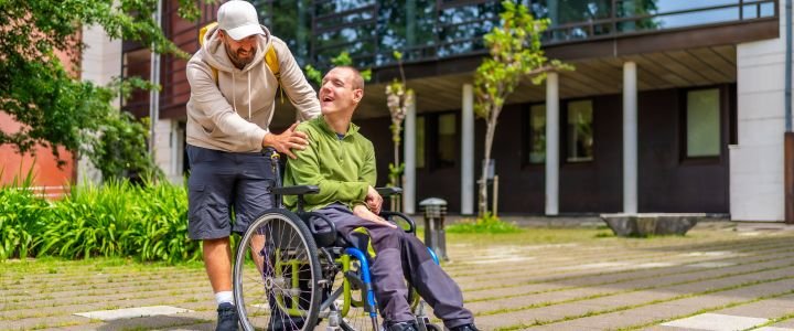 Man with special needs and friend walking along university campus