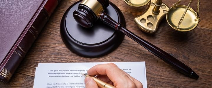 Judge Writing On Legal Documents